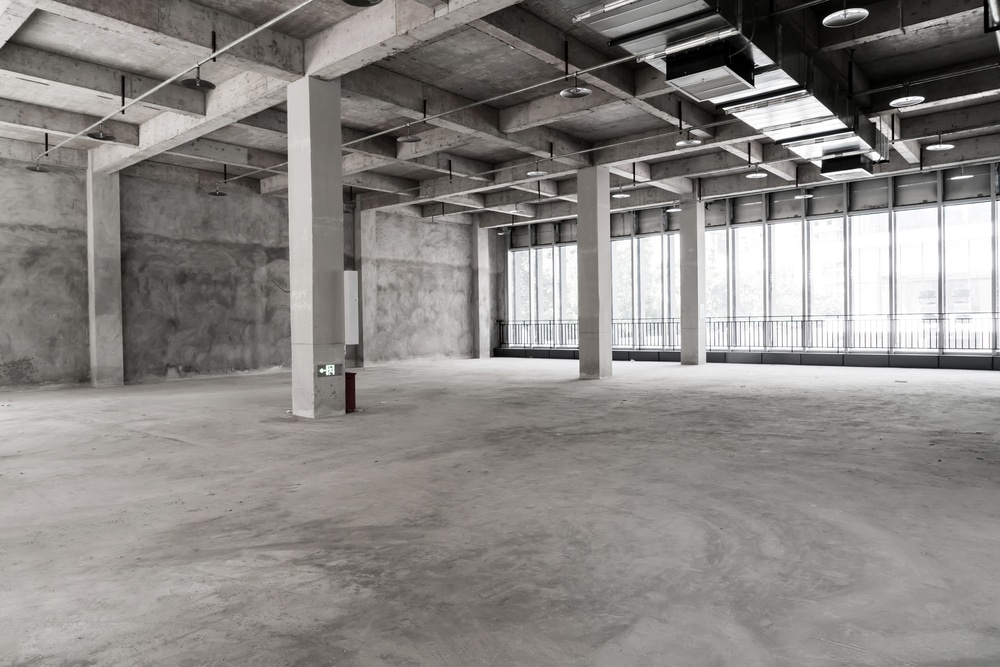 Wide smooth concrete building used as storage room